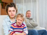 Family sitting on a sofa after a quarell