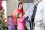 A young woman with her 7 year old daughter shopping in a clothing store. They are looking at a clothes rack.