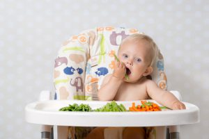Baby girl eating raw food